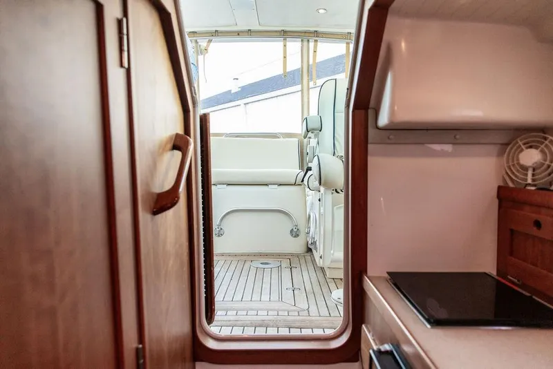 Slide: The Image of Interior view of 2008 Hunt Yachts Surfhunter 29, featuring wooden cabinetry and seating area. - 19