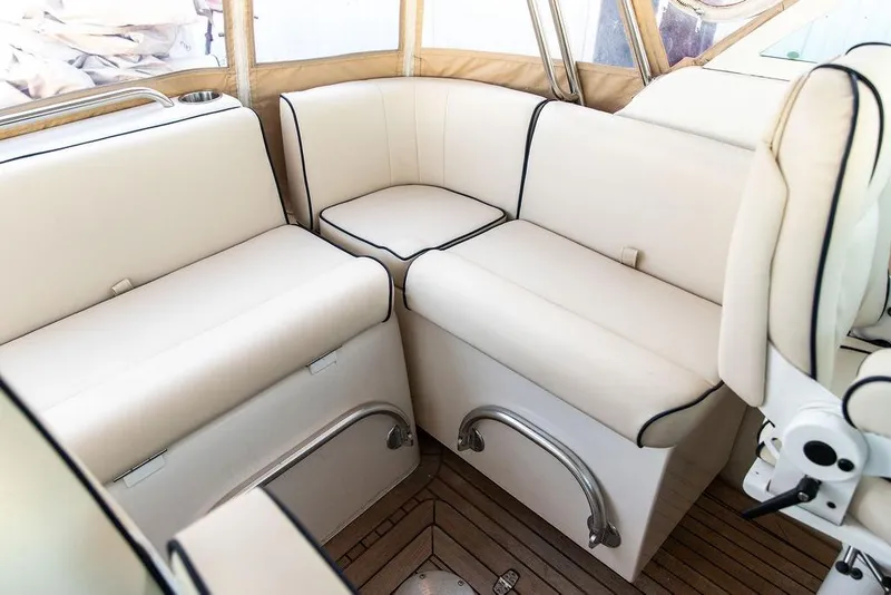 Slide: The Image of 2008 Hunt Yachts Surfhunter 29 interior with beige seating and wooden flooring. - 10