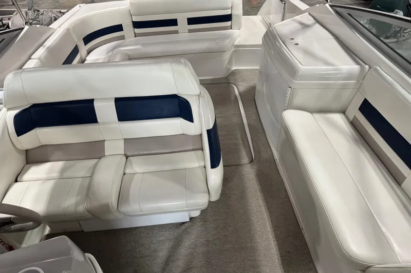 Slide: The Image of 1999 Formula 280 Bowrider interior with white and blue seating, spacious layout. - 10