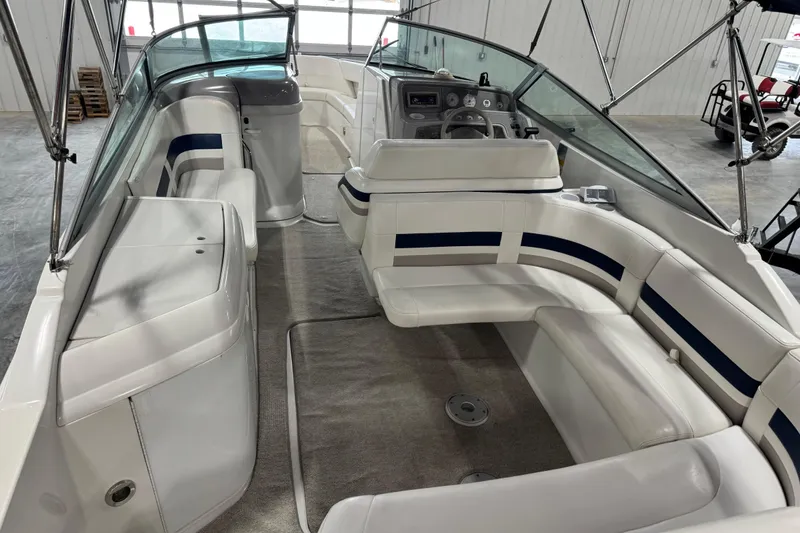 Slide: The Image of 1999 Formula 280 Bowrider interior with white seating and modern dashboard. - 12