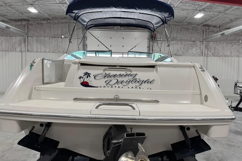 Slide: The Image of 1999 Formula 280 Bowrider boat in storage, featuring "Chasing Daylight" text on the stern. - 5