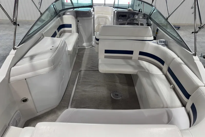 Slide: The Image of 1999 Formula 280 Bowrider interior with white seating and blue accents, showcasing spacious layout. - 6