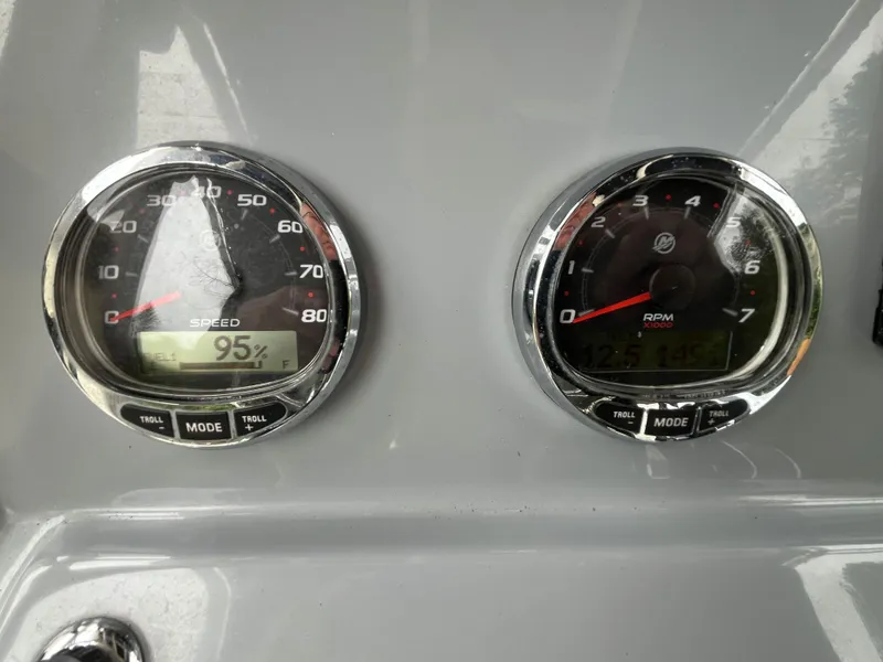 Slide: The Image of Dashboard of a 2021 Bayliner Trophy boat showing speed and RPM gauges. - 11