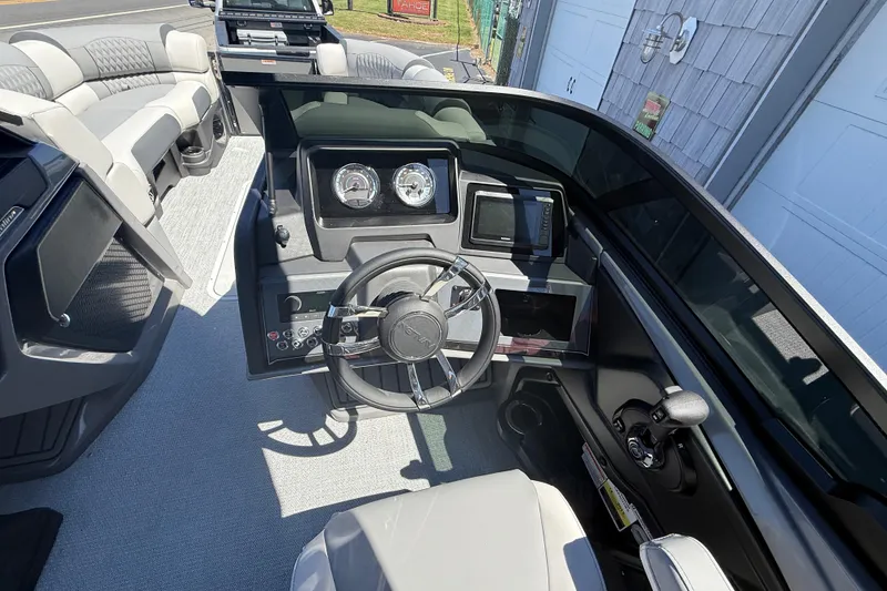 Slide: The Image of 2026 Avalon 2585 Catalina boat dashboard with steering wheel and controls, featuring modern design. - 14