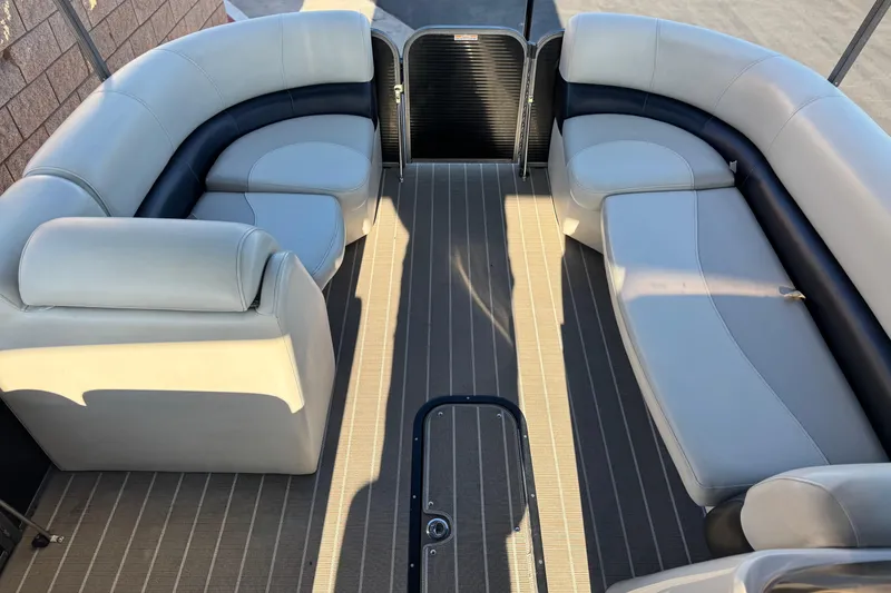 Slide: The Image of 2021 Manitou 23 Aurora LE Standard pontoon boat interior with plush seating. - 10