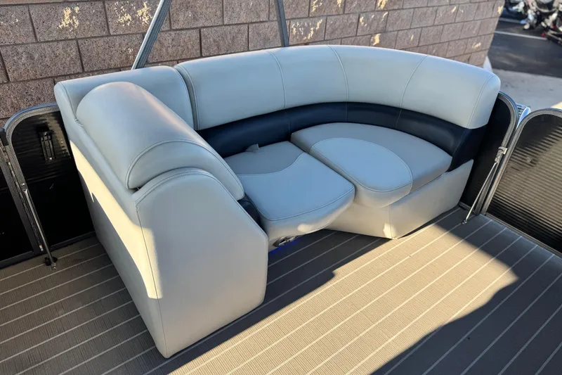 Slide: The Image of 2021 Manitou 23 Aurora LE Standard boat seating, featuring plush, curved upholstery. - 11