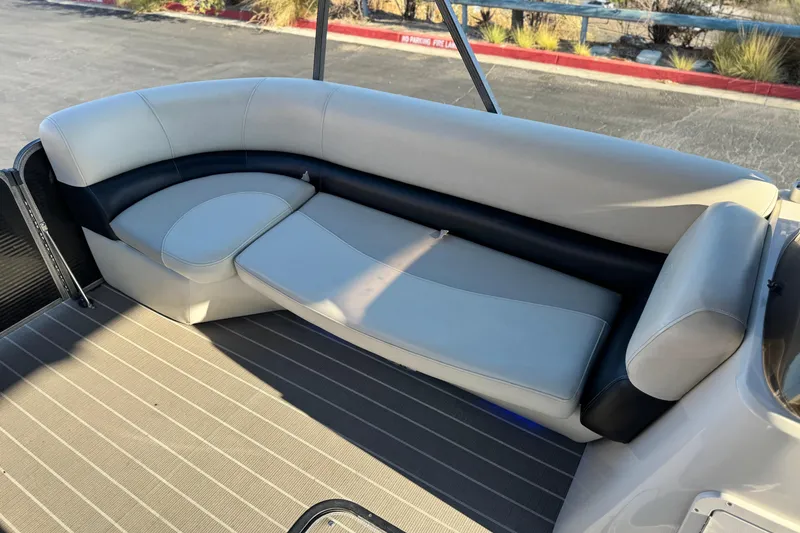 Slide: The Image of 2021 Manitou 23 Aurora LE Standard boat interior with beige and black seating. - 12
