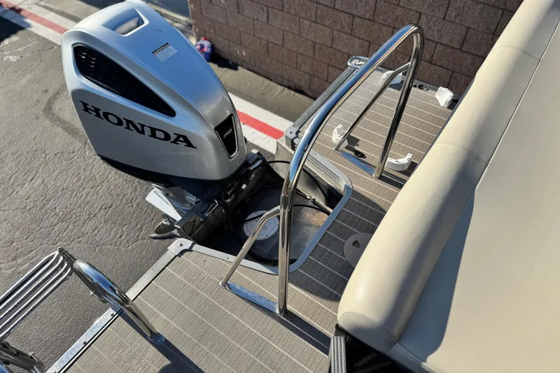Slide: The Image of 2021 Manitou 23 Aurora LE Standard with Honda outboard motor, rear deck view. - 18