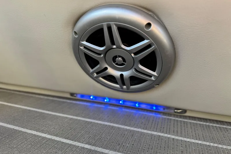 Slide: The Image of Speaker and blue LED lights on 2021 Manitou 23 Aurora LE Standard boat interior. - 21