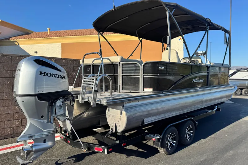 Slide: The Image of 2021 Manitou 23 Aurora LE Standard pontoon boat with Honda outboard motor on trailer. - 6