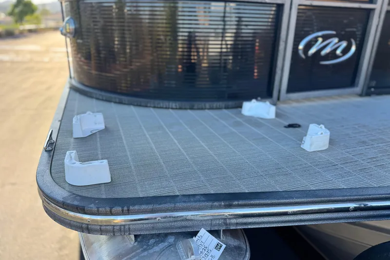 Slide: The Image of 2021 Manitou 23 Aurora LE Standard pontoon deck with logo and fittings. - 8