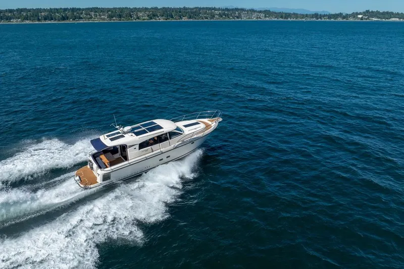 Slide: The Image of Nimbus 405 Coupé 2022 cruising on open water, showcasing sleek design and performance. - 10