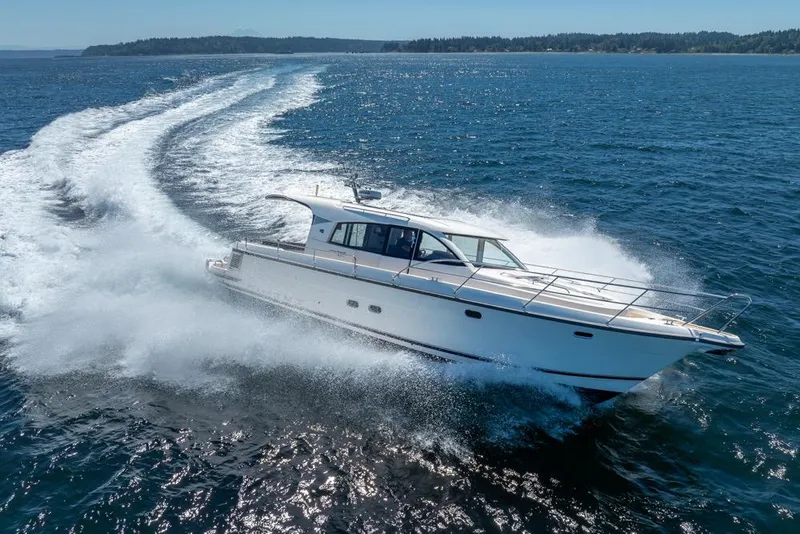 Slide: The Image of 2022 Nimbus 405 Coupé cruising swiftly on open water. - 11