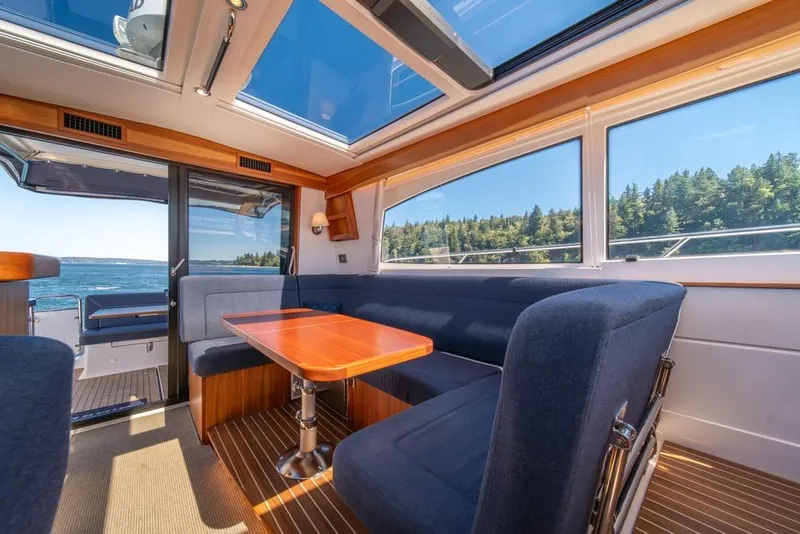 Slide: The Image of Interior of 2022 Nimbus 405 Coupé yacht with panoramic windows and elegant seating. - 15