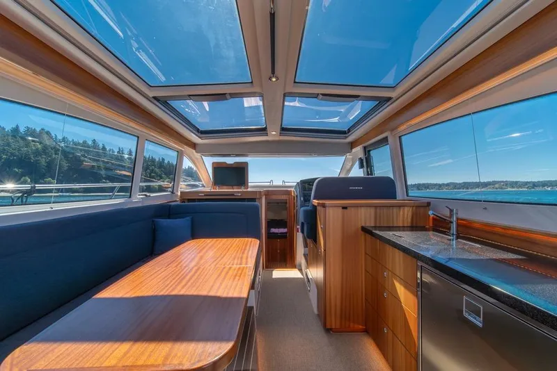 Slide: The Image of Luxurious interior of 2022 Nimbus 405 Coupé yacht with panoramic windows and modern amenities. - 16