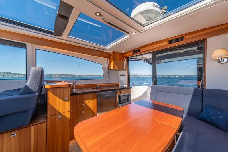 Slide: The Image of Interior of 2022 Nimbus 405 Coupé yacht with panoramic windows and modern furnishings. - 18