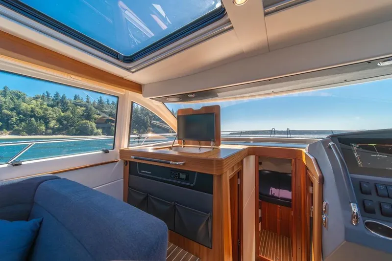 Slide: The Image of Interior of 2022 Nimbus 405 Coupé yacht with scenic ocean view through windows. - 20
