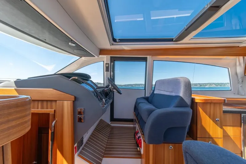 Slide: The Image of Interior of 2022 Nimbus 405 Coupé yacht with modern design and panoramic windows. - 21