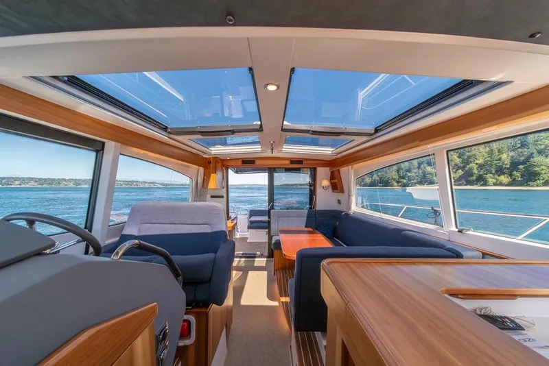 Slide: The Image of Luxurious interior of 2022 Nimbus 405 Coupé yacht with panoramic windows and elegant seating. - 22