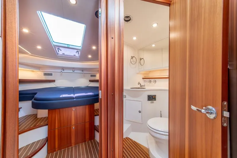 Slide: The Image of Interior of 2022 Nimbus 405 Coupé yacht, featuring a cozy cabin and modern bathroom. - 25