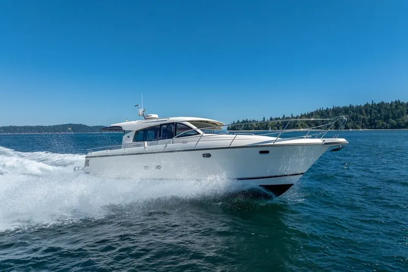 Slide: The Image of 2022 Nimbus 405 Coupé cruising on open water under clear blue sky. - 3