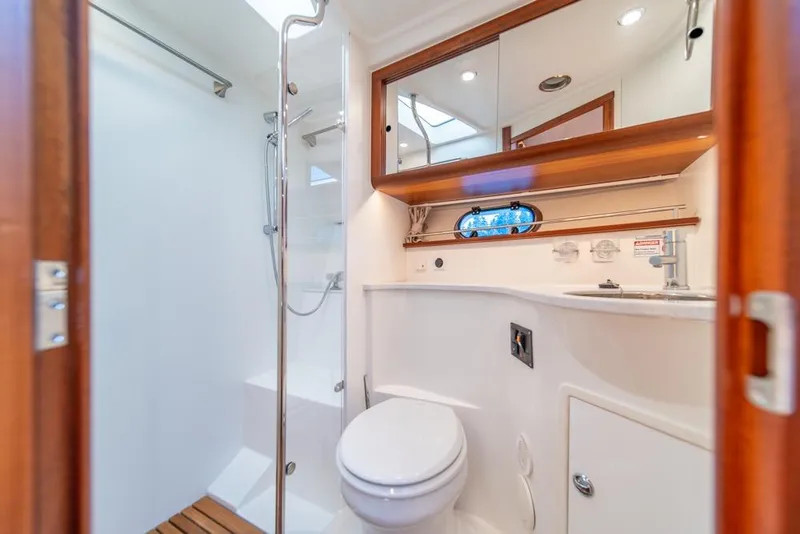 Slide: The Image of Luxurious bathroom in 2022 Nimbus 405 Coupé yacht with modern fixtures and wooden accents. - 30