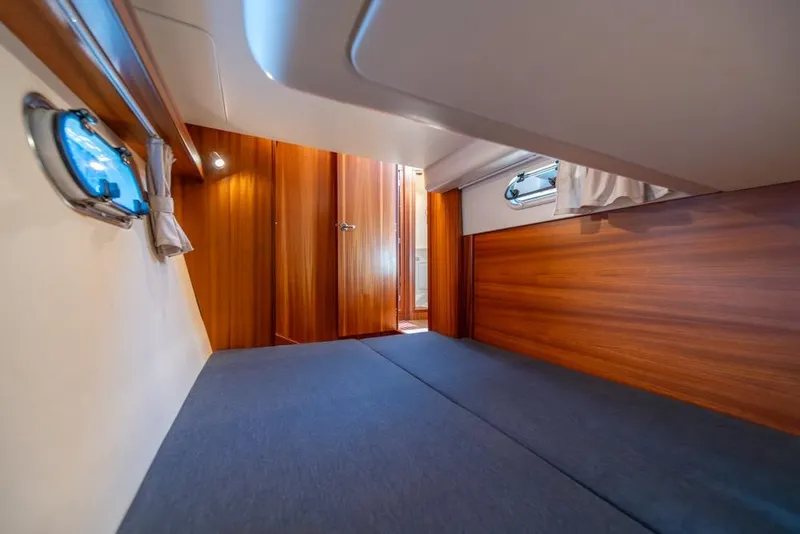 Slide: The Image of Interior cabin of 2022 Nimbus 405 Coupé with wooden paneling and porthole windows. - 37