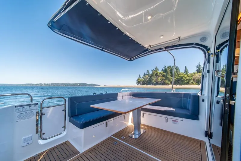 Slide: The Image of Luxurious 2022 Nimbus 405 Coupé yacht with elegant seating and scenic ocean view. - 40