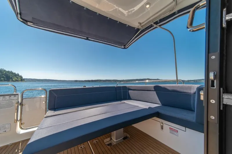 Slide: The Image of Luxurious seating area on a 2022 Nimbus 405 Coupé yacht with scenic ocean view. - 42
