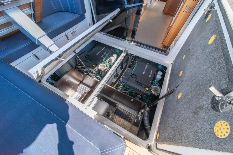Slide: The Image of Engine compartment of 2022 Nimbus 405 Coupé yacht, showcasing mechanical components and seating area. - 43