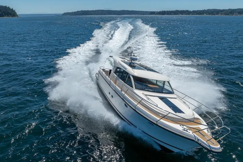 Slide: The Image of 2022 Nimbus 405 Coupé cruising on open water, leaving a wake behind. - 50