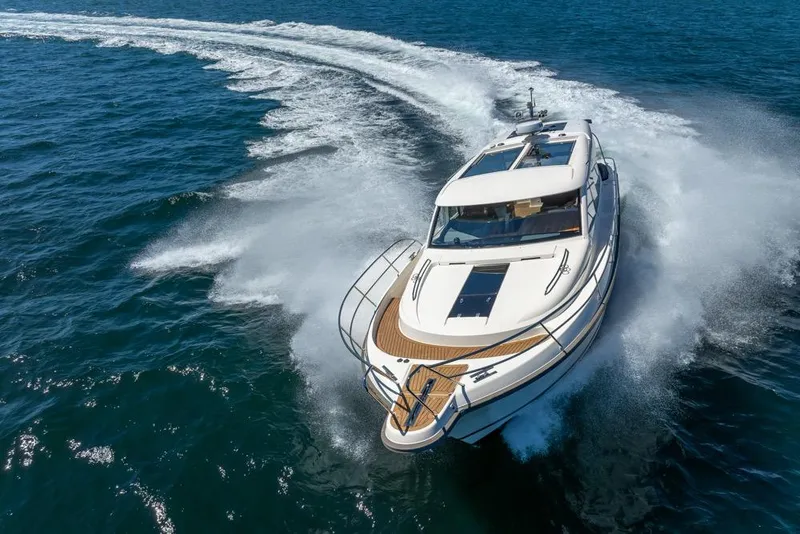 Slide: The Image of 2022 Nimbus 405 Coupé yacht cruising swiftly on open blue waters. - 51