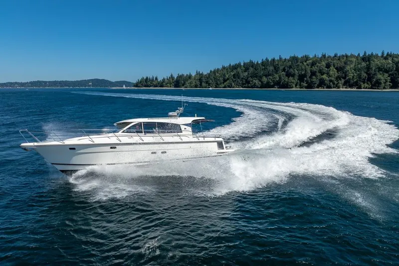 Slide: The Image of 2022 Nimbus 405 Coupé cruising on a clear blue lake with forested shoreline. - 52