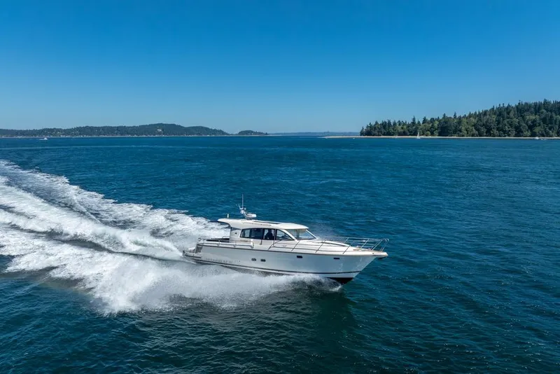 Slide: The Image of Nimbus 405 Coupé 2022 cruising on open water under clear blue skies. - 54