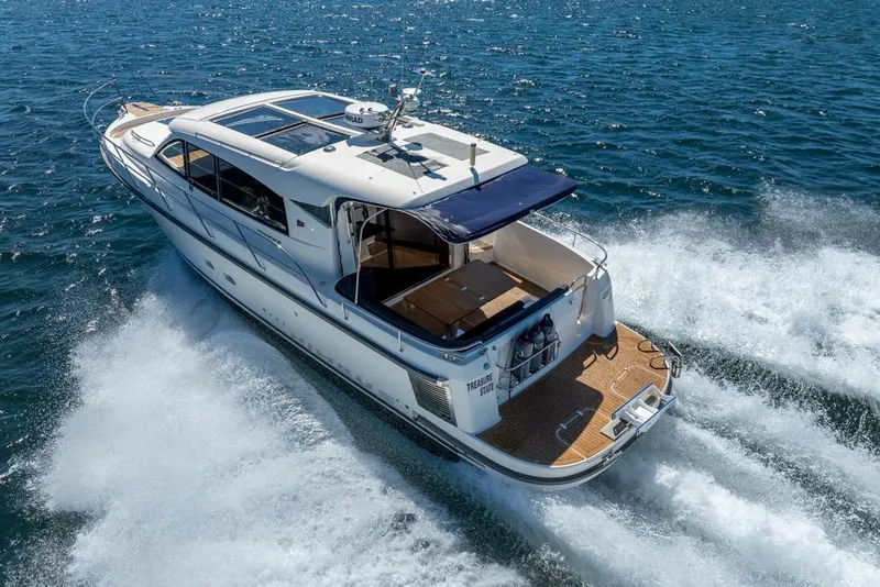 Slide: The Image of 2022 Nimbus 405 Coupé yacht cruising on open water, rear view. - 56