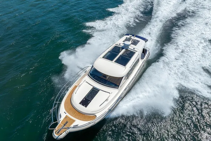 Slide: The Image of Nimbus 405 Coupé 2022 cruising on open water, aerial view showcasing sleek design. - 57
