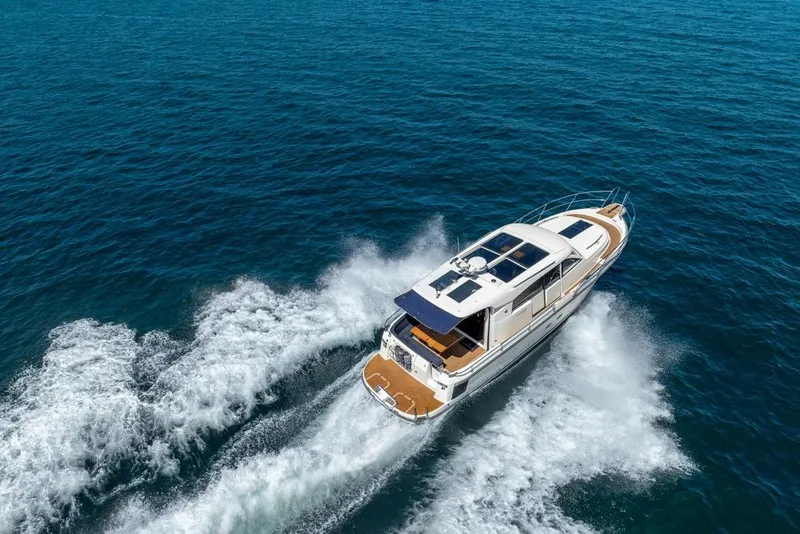 Slide: The Image of 2022 Nimbus 405 Coupé cruising on open blue sea, aerial view. - 58