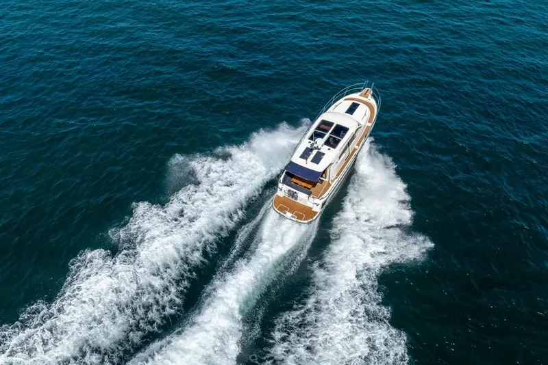 Slide: The Image of 2022 Nimbus 405 Coupé cruising on open blue water, aerial view. - 59