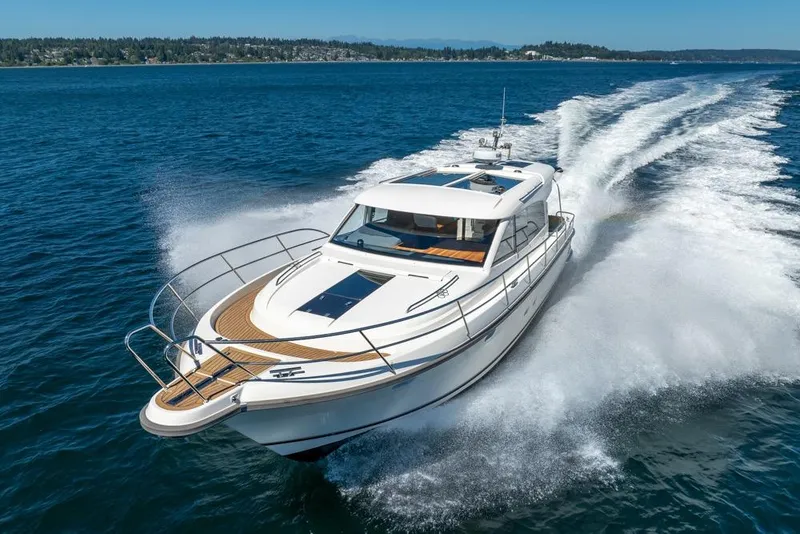 Slide: The Image of 2022 Nimbus 405 Coupé cruising on open water, showcasing sleek design and powerful performance. - 6