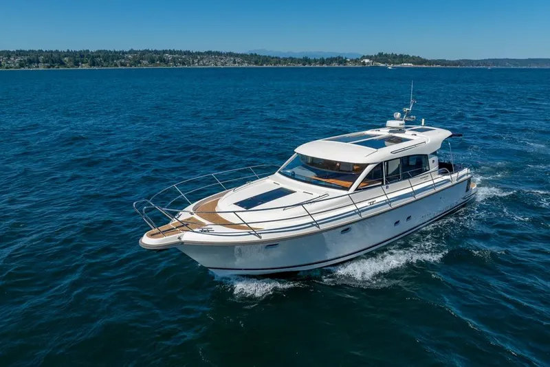 Slide: The Image of 2022 Nimbus 405 Coupé yacht cruising on open blue water. - 60