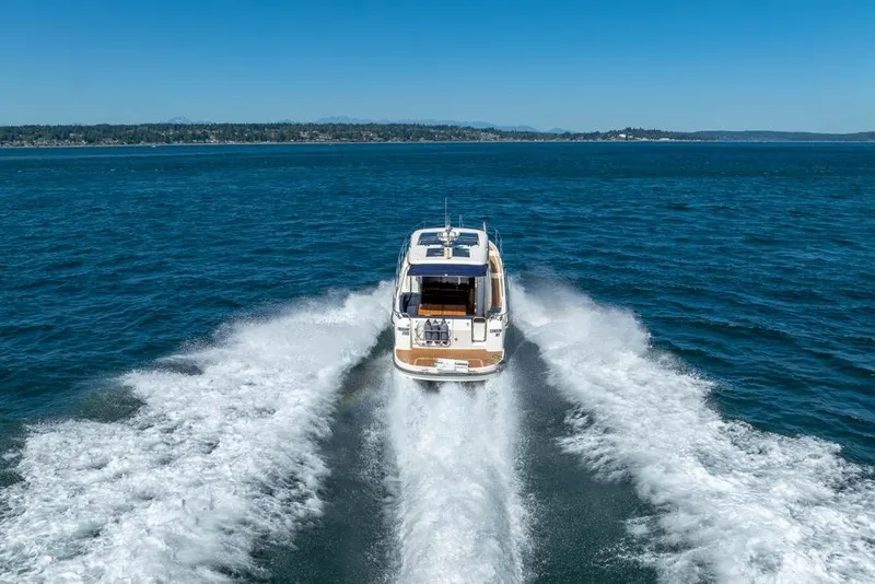 Slide: The Image of 2022 Nimbus 405 Coupé cruising on open water, leaving a wake behind. - 9