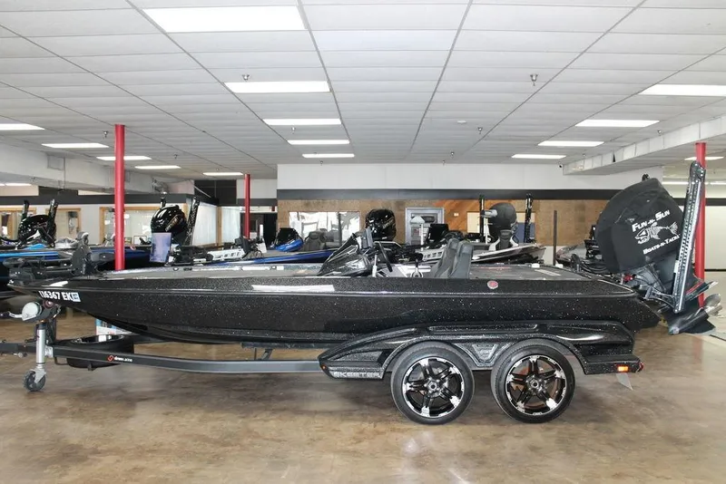Slide: The Image of 2019 Skeeter FX21 LE boat in showroom, black with trailer, side view. - 0