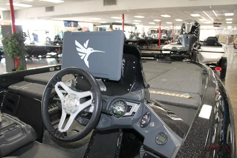 Slide: The Image of 2019 Skeeter FX21 LE boat interior with steering wheel and navigation system. - 2