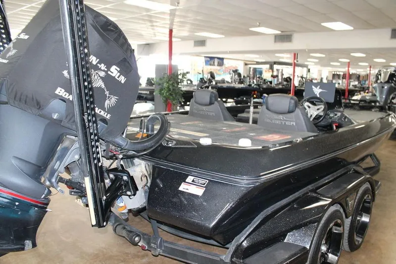 Slide: The Image of 2019 Skeeter FX21 LE bass boat displayed indoors, featuring dual seats and powerful engine. - 3