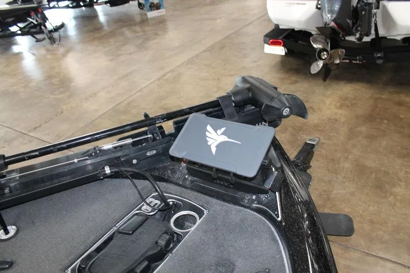 Slide: The Image of 2019 Skeeter FX21 LE boat interior with fishing equipment and motor detail. - 6