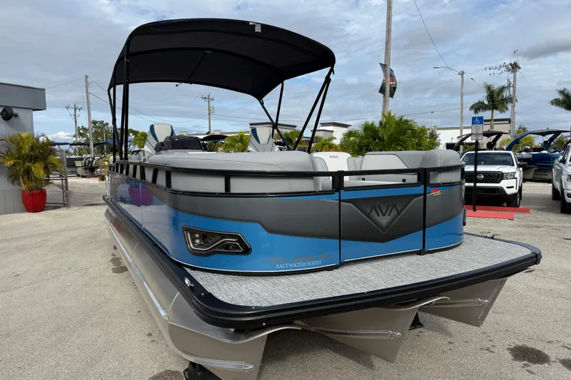 Slide: The Image of 2026 Avalon 2385 Venture 85 Quad Lounger Tri Toon boat with canopy, parked outdoors. - 31