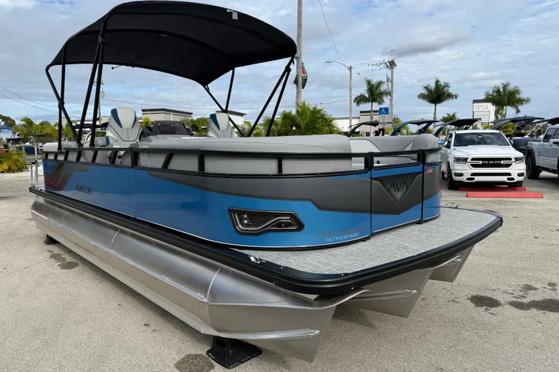 Slide: The Image of 2026 Avalon 2385 Venture 85 Quad Lounger Tri Toon boat with canopy, parked outdoors. - 32