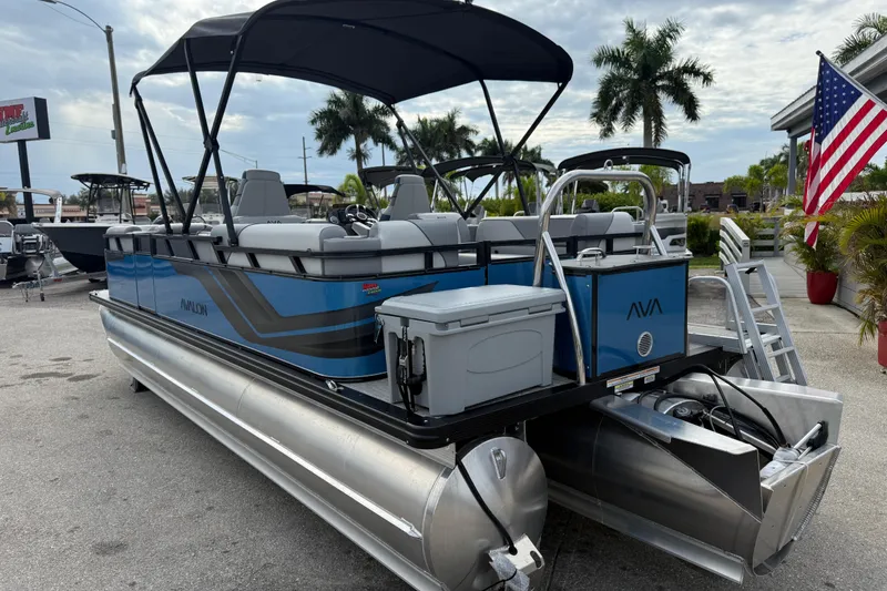 Slide: The Image of 2026 Avalon 2385 Venture 85 Quad Lounger Tri Toon boat with canopy, parked outdoors. - 37
