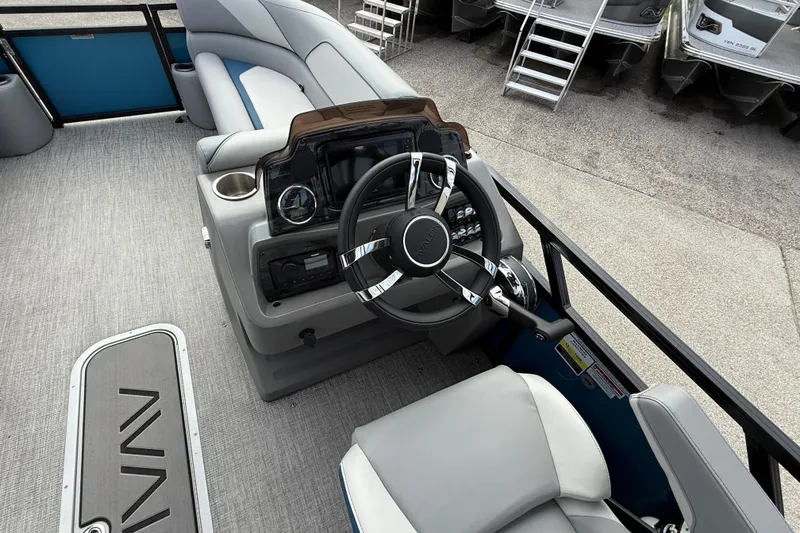 Slide: The Image of 2026 Avalon 2385 Venture 85 Quad Lounger boat interior with steering wheel and seating. - 52