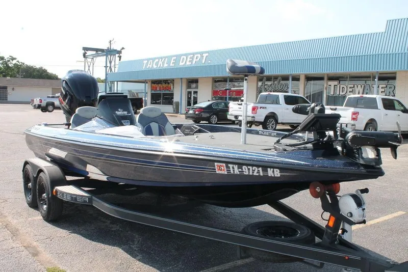 Slide: The Image of 2021 Skeeter ZX225 boat parked outside a tackle shop, showcasing sleek design and modern features. - 2